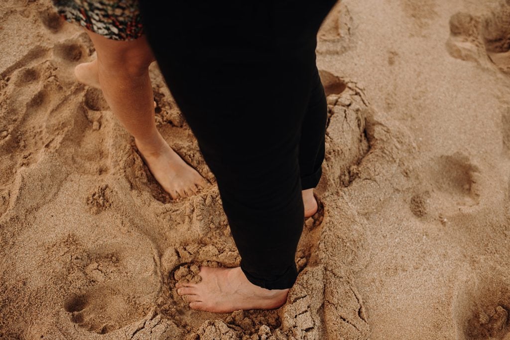Chantelle + Myles feet in the sand