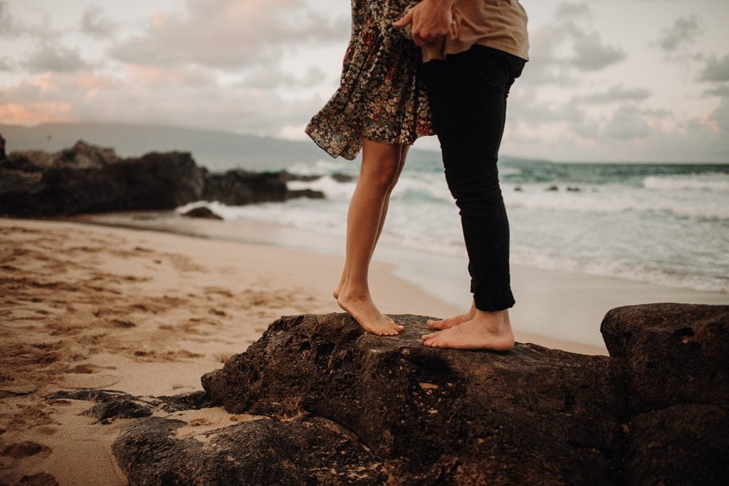 close up of couple standing on a rock