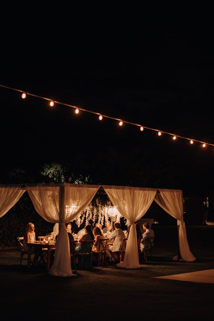 Guests enjoying the beachside atmosphere during the Maui micro wedding celebration.