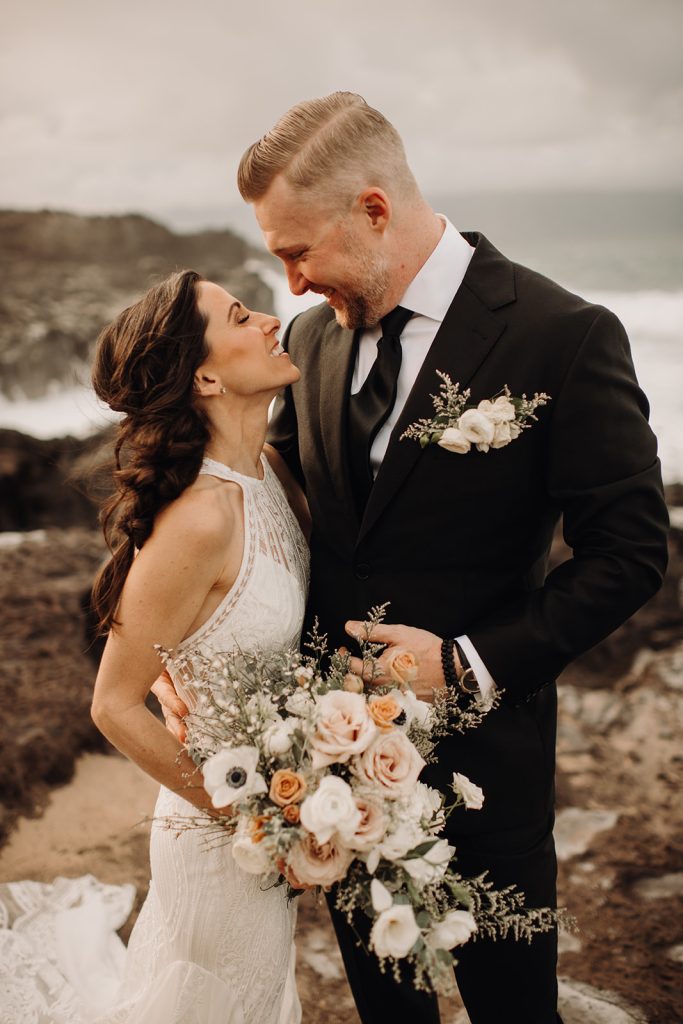 The couple gazes into each other's eyes, surrounded by the natural beauty of Ironwoods Beach in Kapalua for their elopement photography.