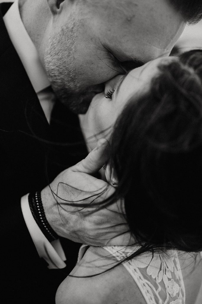 close up of couple kissing in black and white