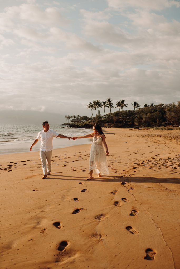 Maui elopement locations offer a tropical paradise in South Maui's Wailea area, featuring palm trees and lava rocks.