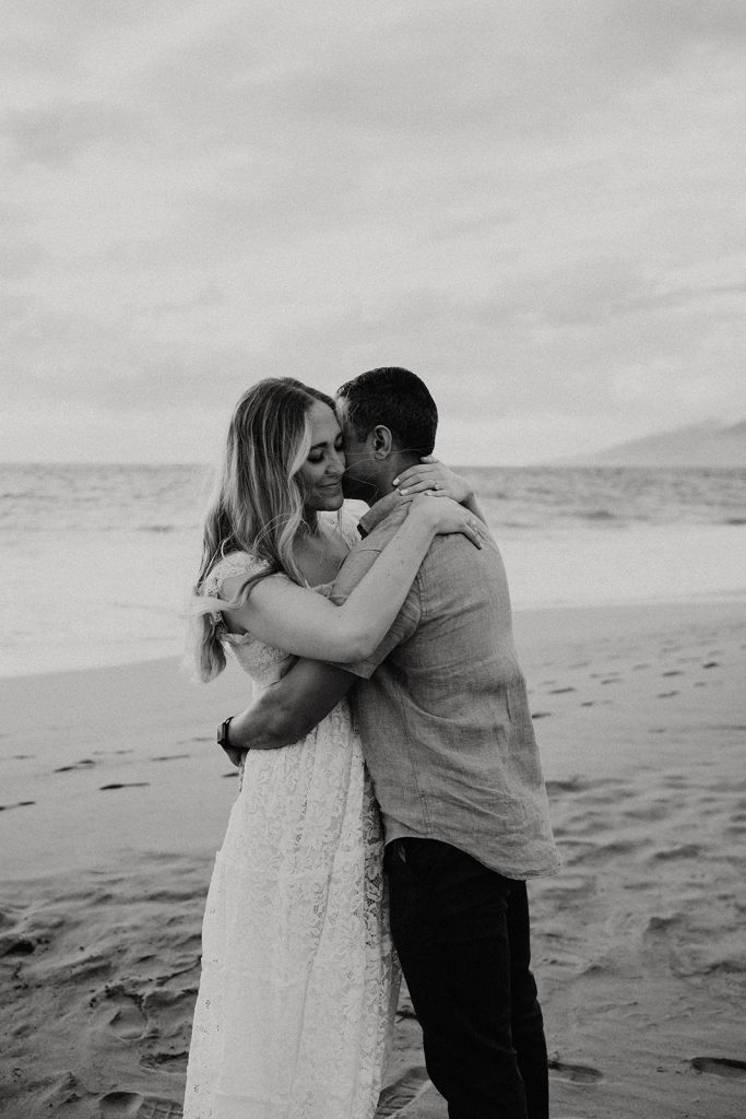 couple embracing on Po'olenalena Beach in Maui