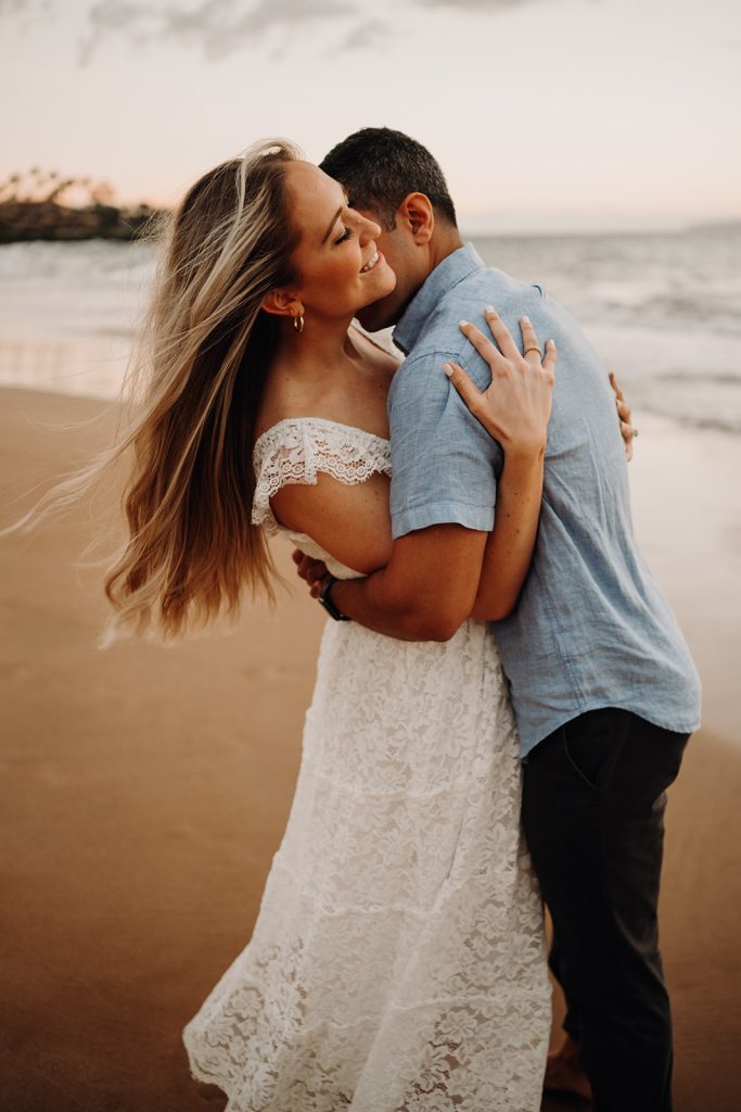 couple embracing on Po'olenalena Beach in Maui