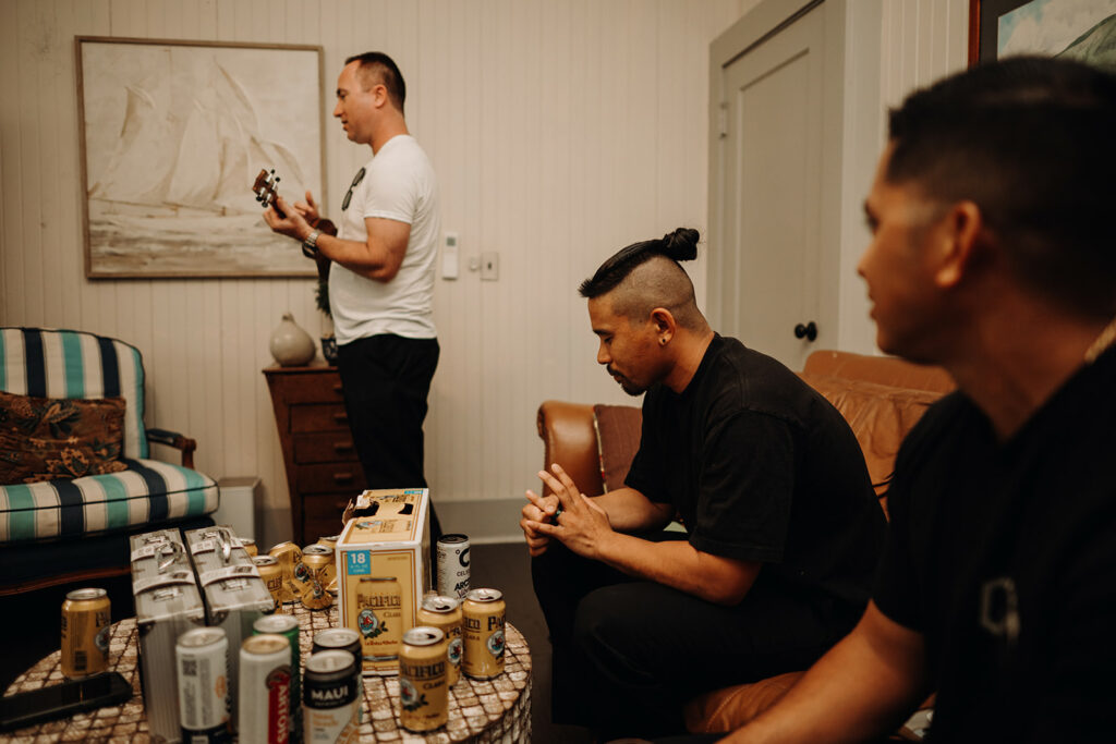 groom and groomsmen jamming out with a ukelele while getting ready